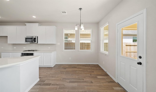 2614 Bisbee Rd, League City, TX 77573 - kitchen with appliances with stainless steel finishes, light wood finished floors, white cabinets, decorative backsplash, and recessed lighting