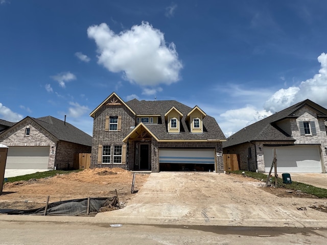 2614 Bisbee Rd, League City, TX 77573 - view of front of home featuring brick siding, driveway, and a shingled roof