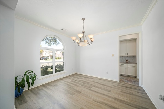 2111 Scenic Hollow Ct, Katy, TX 77450 - unfurnished dining area with ornamental molding, a chandelier, and light wood-style flooring