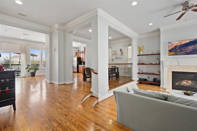 2841 Sherwin St, Houston, TX 77007 - living room featuring light wood finished floors, a ceiling fan, a fireplace, crown molding, and recessed lighting