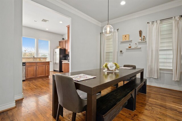 2841 Sherwin St, Houston, TX 77007 - dining space with wood finished floors, crown molding, and recessed lighting