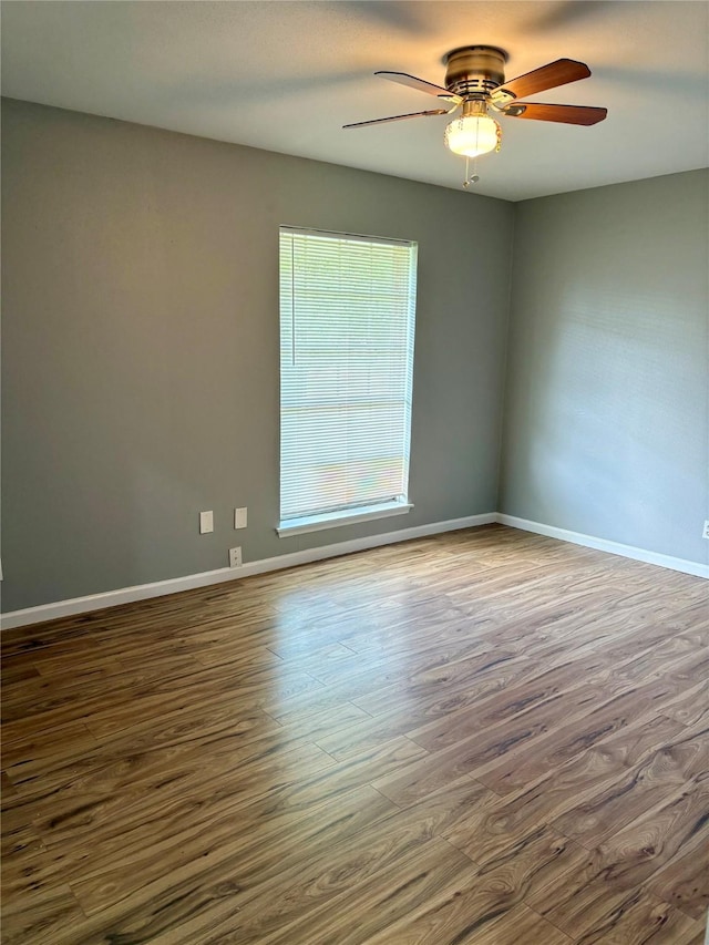 10434 Rocky Hollow Rd, La Porte, TX 77571 - empty room featuring dark wood-style floors and ceiling fan