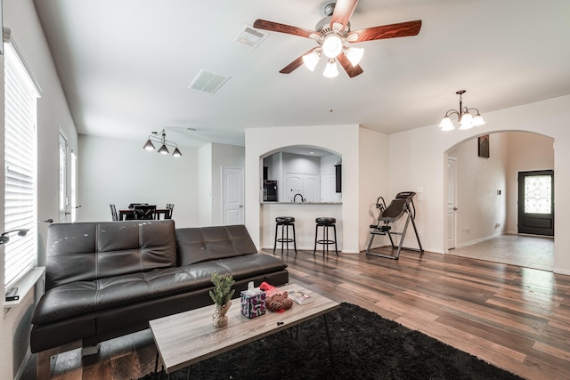 901 Jefferson Ave, Cleveland, TX 77327 - living area featuring arched walkways, ceiling fan, and wood finished floors