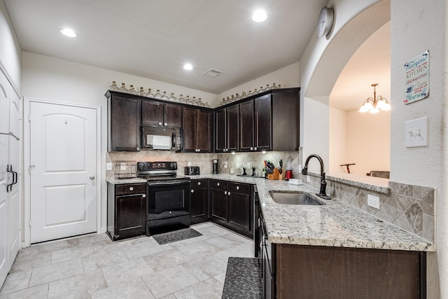 901 Jefferson Ave, Cleveland, TX 77327 - kitchen with black appliances, backsplash, light stone counters, and recessed lighting