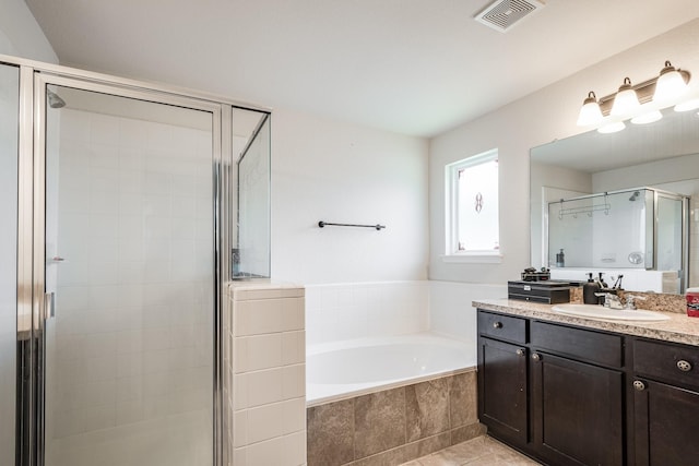 901 Jefferson Ave, Cleveland, TX 77327 - full bath featuring vanity, a garden tub, a stall shower, and tile patterned floors
