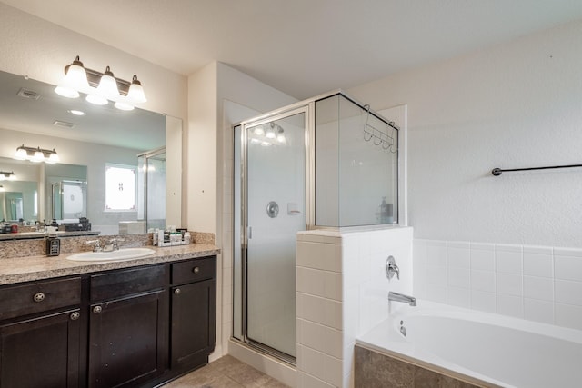 901 Jefferson Ave, Cleveland, TX 77327 - full bathroom featuring a bath, vanity, a shower stall, and tile patterned floors