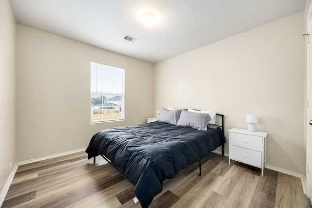 814 Eagles Glide Dr, Houston, TX 77090 - bedroom with light wood-type flooring and baseboards