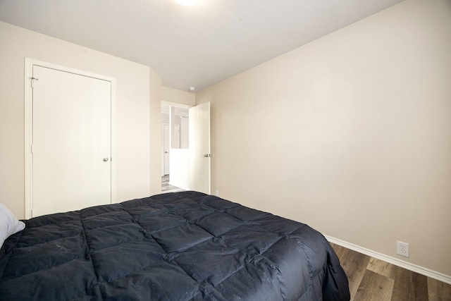 814 Eagles Glide Dr, Houston, TX 77090 - bedroom with wood finished floors and baseboards