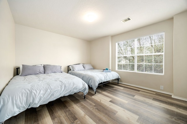 814 Eagles Glide Dr, Houston, TX 77090 - bedroom with wood finished floors and baseboards