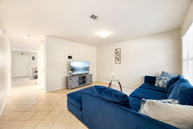 814 Eagles Glide Dr, Houston, TX 77090 - living room featuring light tile patterned flooring and baseboards