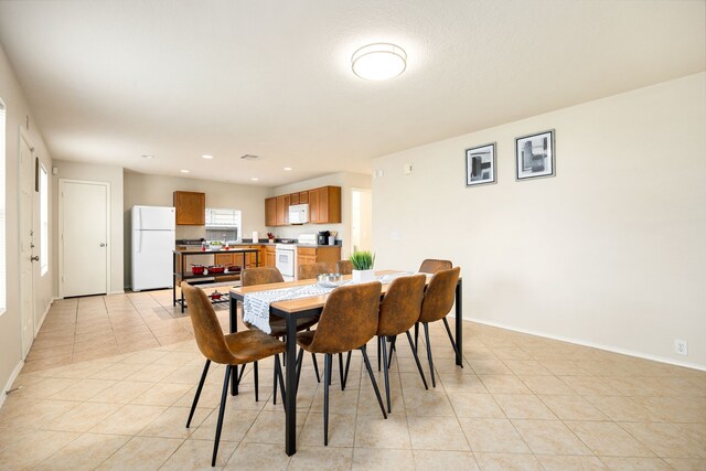 814 Eagles Glide Dr, Houston, TX 77090 - dining space with light tile patterned floors and recessed lighting
