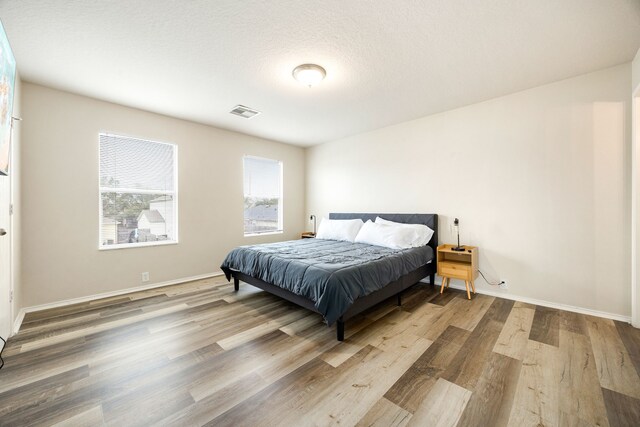 814 Eagles Glide Dr, Houston, TX 77090 - bedroom with wood finished floors and baseboards