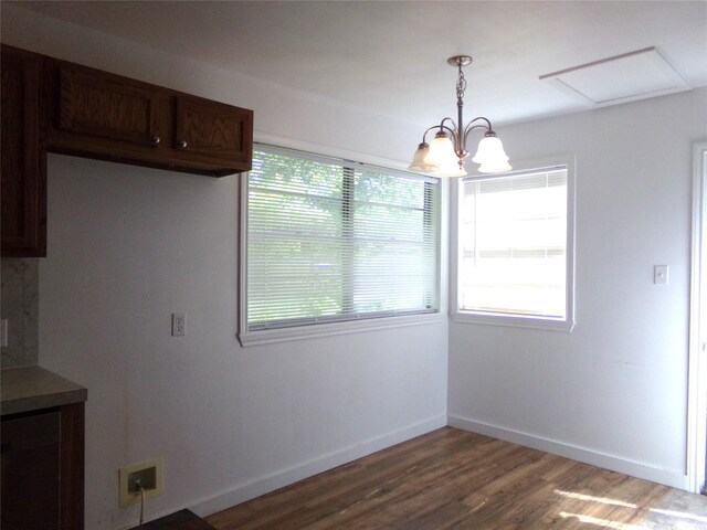 505 S Saint Andrews St, Weimar, TX 78962 - unfurnished dining area with a chandelier, wood finished floors, and attic access