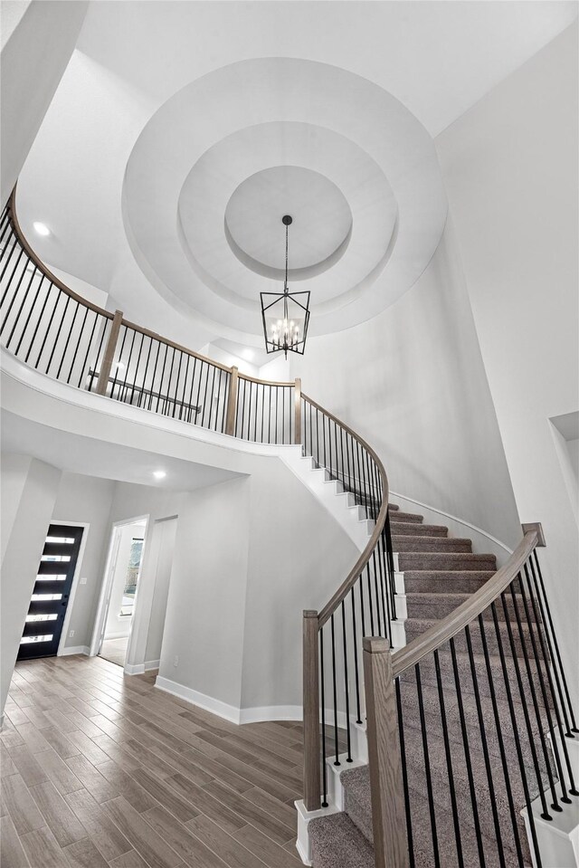 3185 Stingray Cove Dr, Katy, TX 77493 - staircase with wood finished floors, a high ceiling, and a chandelier