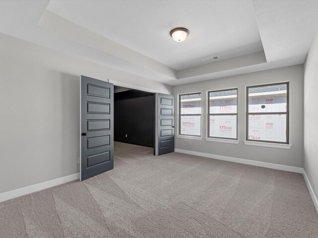 3185 Stingray Cove Dr, Katy, TX 77493 - spare room featuring a raised ceiling and light carpet