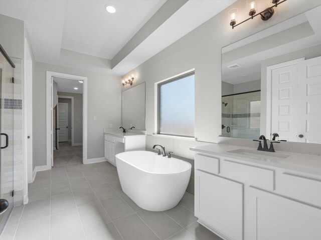 3185 Stingray Cove Dr, Katy, TX 77493 - full bath featuring a stall shower, two vanities, a freestanding bath, recessed lighting, and tile patterned flooring