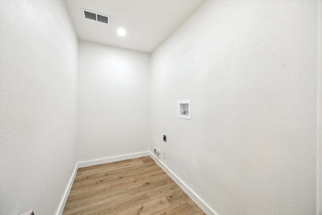 5859 Belmark St, Houston, TX 77033 - laundry area featuring washer hookup, light wood-type flooring, hookup for an electric dryer, and recessed lighting