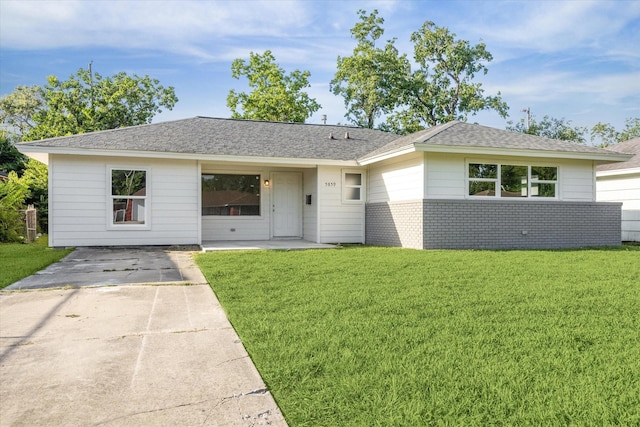 5859 Belmark St, Houston, TX 77033 - ranch-style house with a front yard, a shingled roof, and brick siding