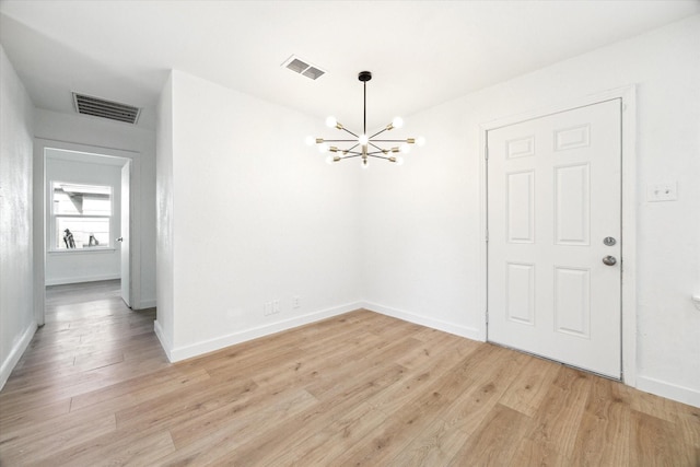 5859 Belmark St, Houston, TX 77033 - unfurnished dining area with a chandelier and light wood-type flooring