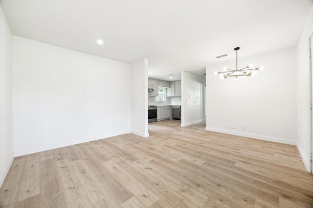 5859 Belmark St, Houston, TX 77033 - empty room featuring a chandelier and light wood finished floors
