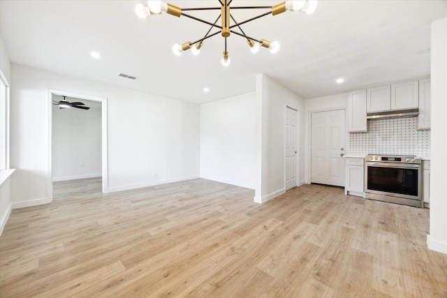 5859 Belmark St, Houston, TX 77033 - unfurnished living room featuring a chandelier, light wood finished floors, and recessed lighting