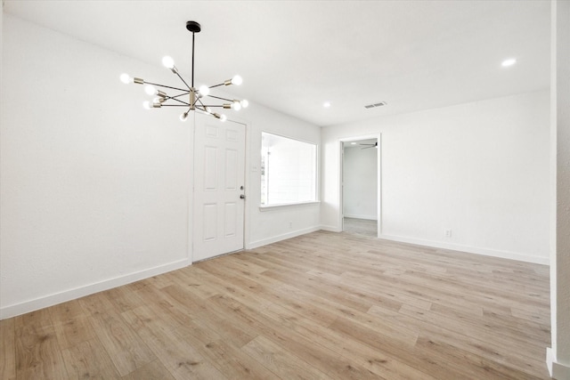 5859 Belmark St, Houston, TX 77033 - unfurnished room with a chandelier, light wood-style flooring, and recessed lighting