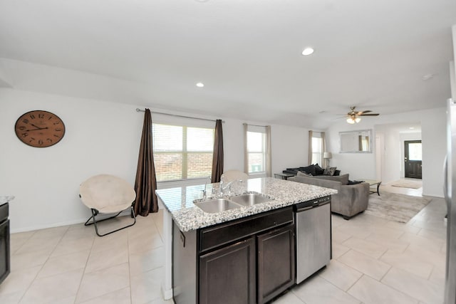 1404 Woods Lake Ct, Houston, TX 77047 - kitchen with stainless steel dishwasher, a ceiling fan, plenty of natural light, an island with sink, and recessed lighting
