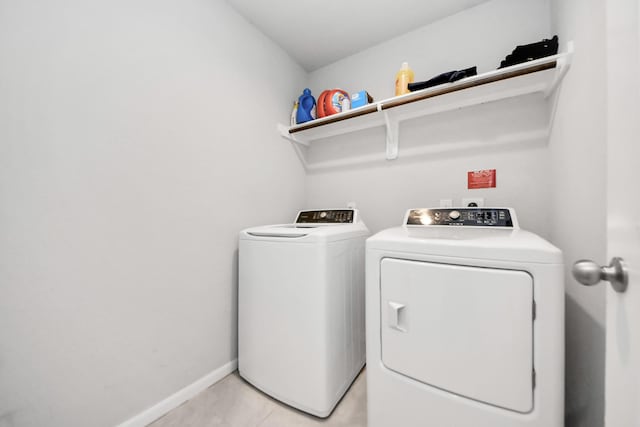 1404 Woods Lake Ct, Houston, TX 77047 - laundry room with washer and clothes dryer and light tile patterned flooring