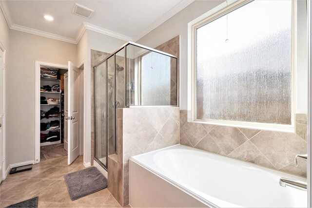 31144 Aspen Gate Trl, Spring, TX 77386 - bathroom featuring a bath, a shower stall, a spacious closet, ornamental molding, and healthy amount of natural light