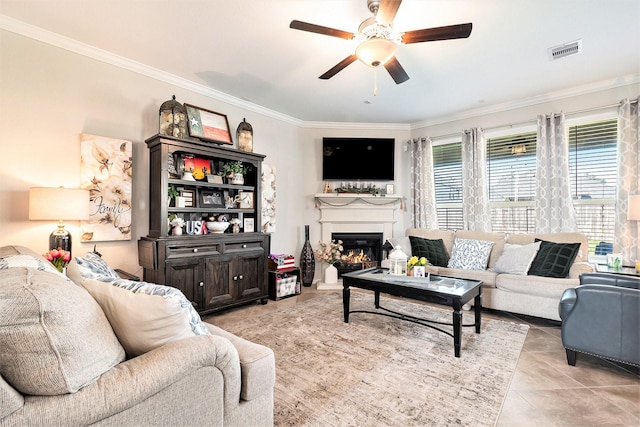 31144 Aspen Gate Trl, Spring, TX 77386 - living room with ornamental molding, a ceiling fan, a glass covered fireplace, and light tile patterned floors