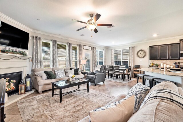31144 Aspen Gate Trl, Spring, TX 77386 - living room featuring a ceiling fan, ornamental molding, a warm lit fireplace, light tile patterned flooring, and recessed lighting