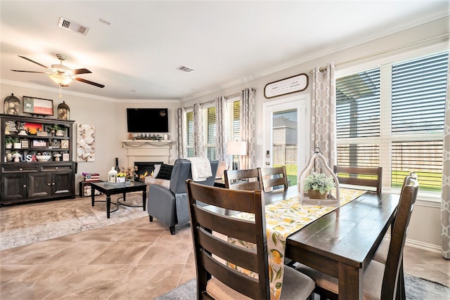 31144 Aspen Gate Trl, Spring, TX 77386 - dining area with crown molding, ceiling fan, a glass covered fireplace, and light tile patterned flooring