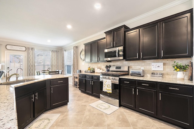 31144 Aspen Gate Trl, Spring, TX 77386 - kitchen with stainless steel appliances, ornamental molding, tasteful backsplash, light stone countertops, and light tile patterned floors