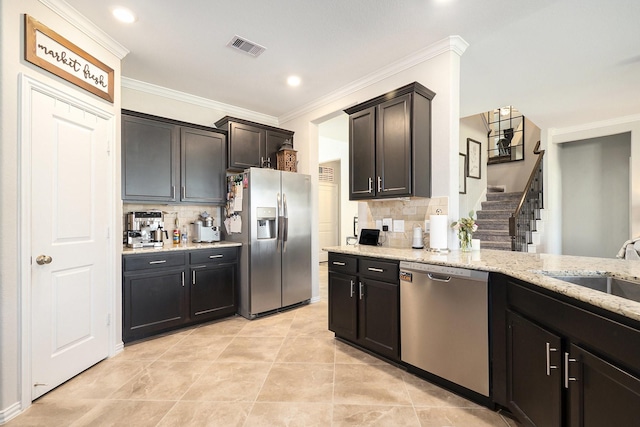 31144 Aspen Gate Trl, Spring, TX 77386 - kitchen with stainless steel appliances, backsplash, crown molding, light stone countertops, and light tile patterned floors