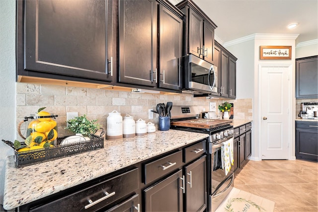 31144 Aspen Gate Trl, Spring, TX 77386 - kitchen featuring stainless steel appliances, ornamental molding, decorative backsplash, light stone countertops, and light tile patterned floors