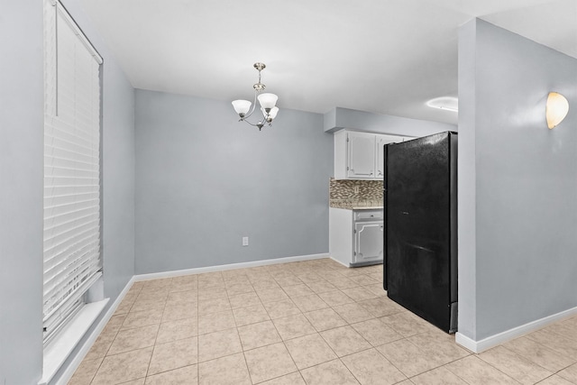 5237 Arboles Dr Unit C, Houston, TX 77035 - kitchen featuring freestanding refrigerator, a chandelier, decorative backsplash, white cabinetry, and light countertops