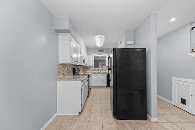 5237 Arboles Dr Unit C, Houston, TX 77035 - kitchen with black appliances, light countertops, light tile patterned flooring, and decorative backsplash