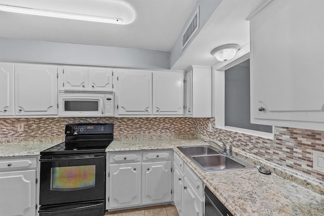 5237 Arboles Dr Unit C, Houston, TX 77035 - kitchen with black electric range oven, white microwave, white cabinetry, and decorative backsplash