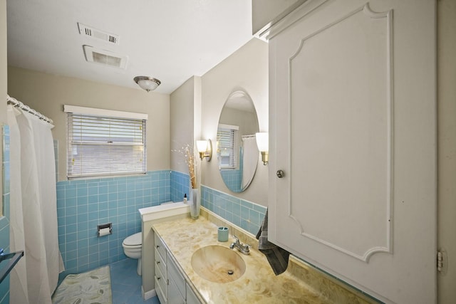 5810 Wigton Dr, Houston, TX 77096 - full bath with tile patterned flooring, vanity, tile walls, a shower with shower curtain, and a wainscoted wall