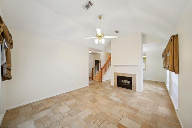 2920 Elm Grove Ct, Kingwood, TX 77339 - unfurnished living room with stone tile floors, ceiling fan, vaulted ceiling, and a fireplace
