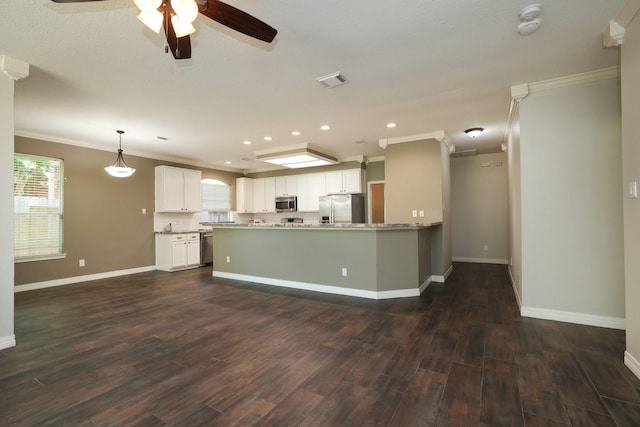 9111 Sutter Ranch Dr, Houston, TX 77064 - kitchen featuring appliances with stainless steel finishes, crown molding, healthy amount of natural light, ceiling fan, and dark wood finished floors