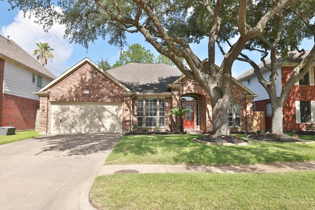 9111 Sutter Ranch Dr, Houston, TX 77064 - traditional-style home featuring brick siding, an attached garage, concrete driveway, a front lawn, and a shingled roof