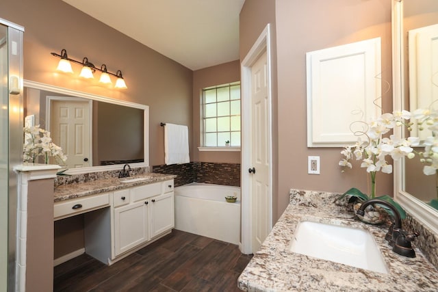9111 Sutter Ranch Dr, Houston, TX 77064 - full bathroom featuring wood finished floors, vanity, a garden tub, and a chandelier