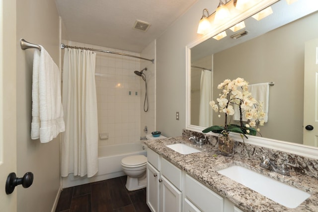 9111 Sutter Ranch Dr, Houston, TX 77064 - bathroom featuring double vanity, shower / bathtub combination with curtain, and wood finished floors