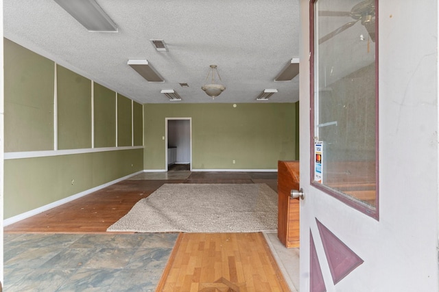 6738 US Highway 190 E, Livingston, TX 77351 - empty room featuring a textured ceiling and wood finished floors