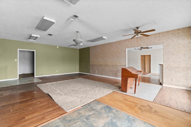 6738 US Highway 190 E, Livingston, TX 77351 - unfurnished room with a ceiling fan, wood finished floors, and a textured ceiling