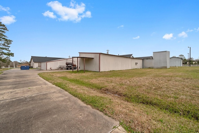 6738 US Highway 190 E, Livingston, TX 77351 - view of grassy yard with a pole building, an outdoor structure, and driveway
