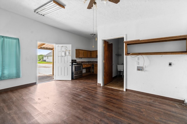 6738 US Highway 190 E, Livingston, TX 77351 - unfurnished living room featuring a ceiling fan, lofted ceiling, dark wood-style floors, and a textured ceiling