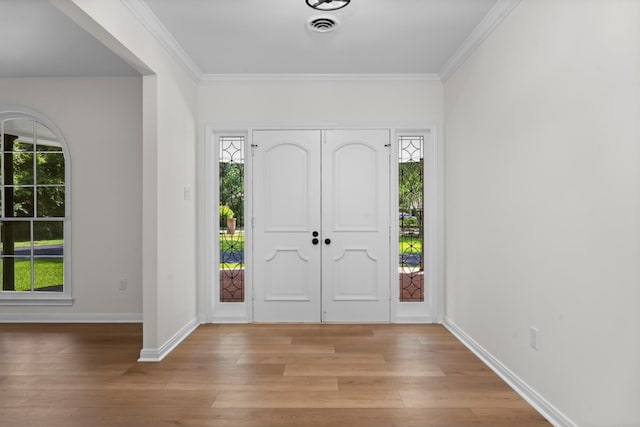 3 Briarwood Dr, Conroe, TX 77301 - entrance foyer with light wood-type flooring, healthy amount of natural light, and crown molding