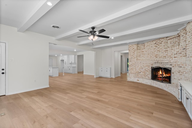 3 Briarwood Dr, Conroe, TX 77301 - unfurnished living room with a fireplace, beamed ceiling, ceiling fan, light wood-style flooring, and recessed lighting